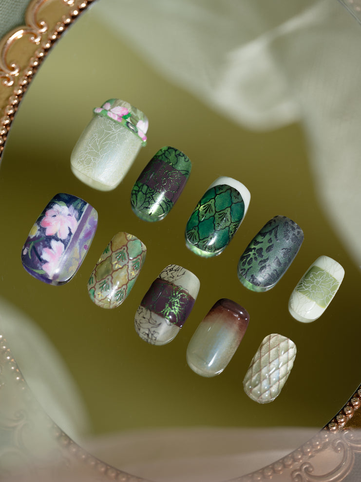 Green press-on nail with hand-painted  floral design”