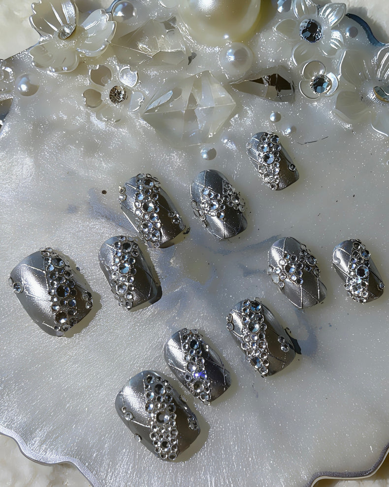 Luxury silver press on nails featuring a lace pattern and crystal accents